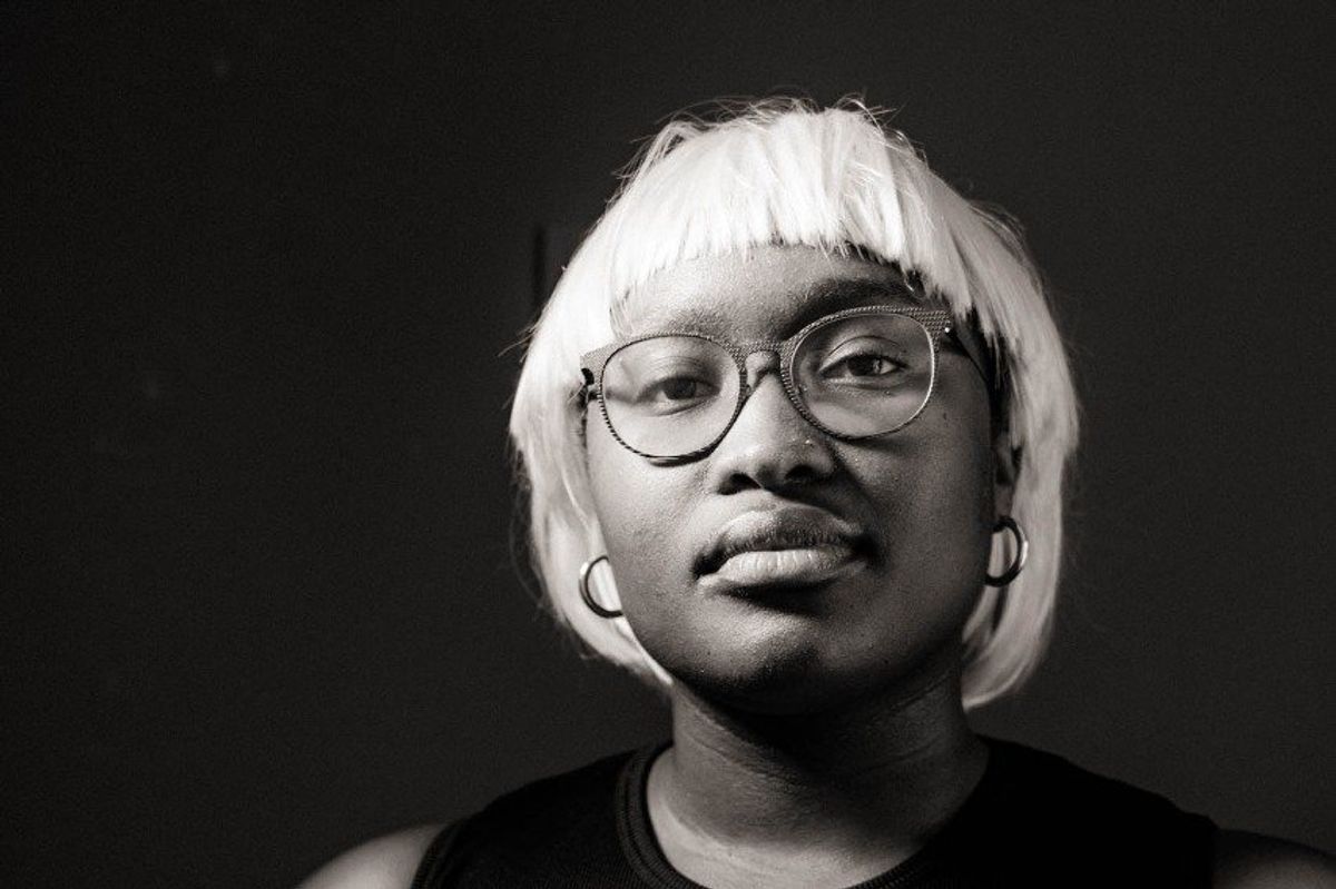 A black and white image of filmmaker Sandulela Asanda looking straight at the camera.
