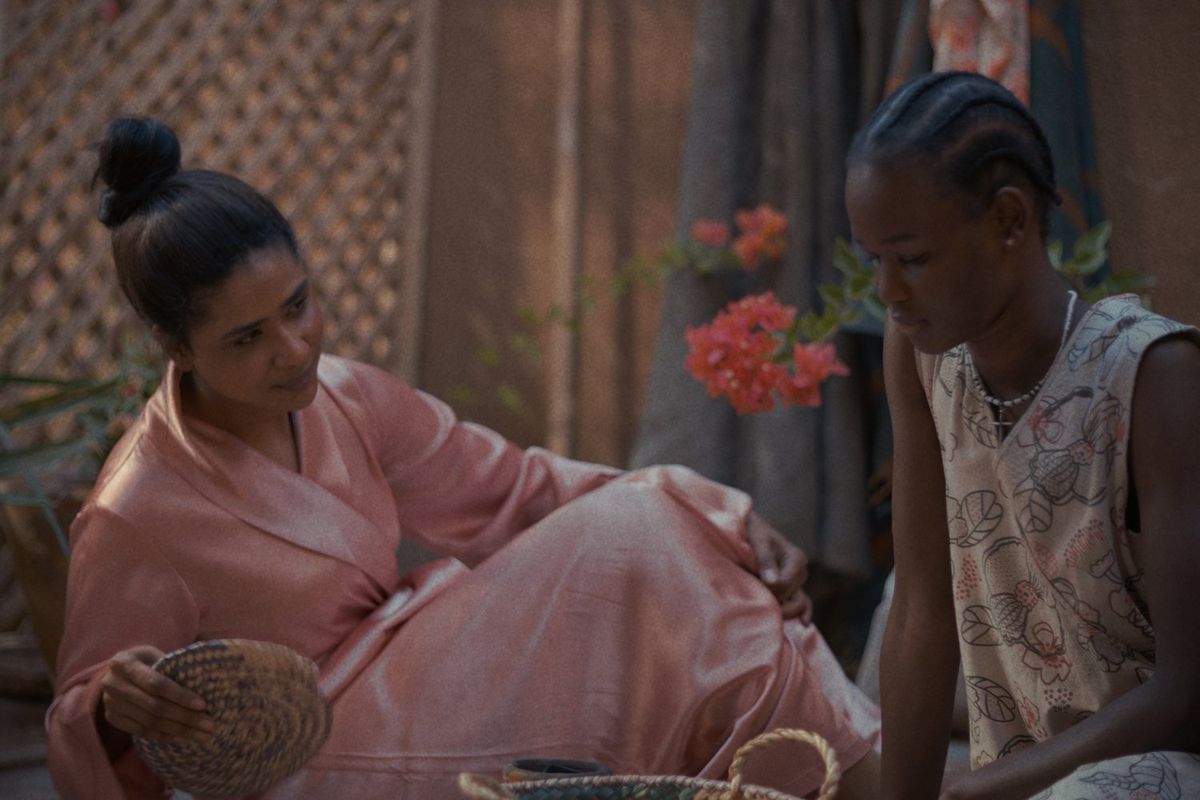 An image from 'Goobye Julia' of two women sitting next to each other talking.