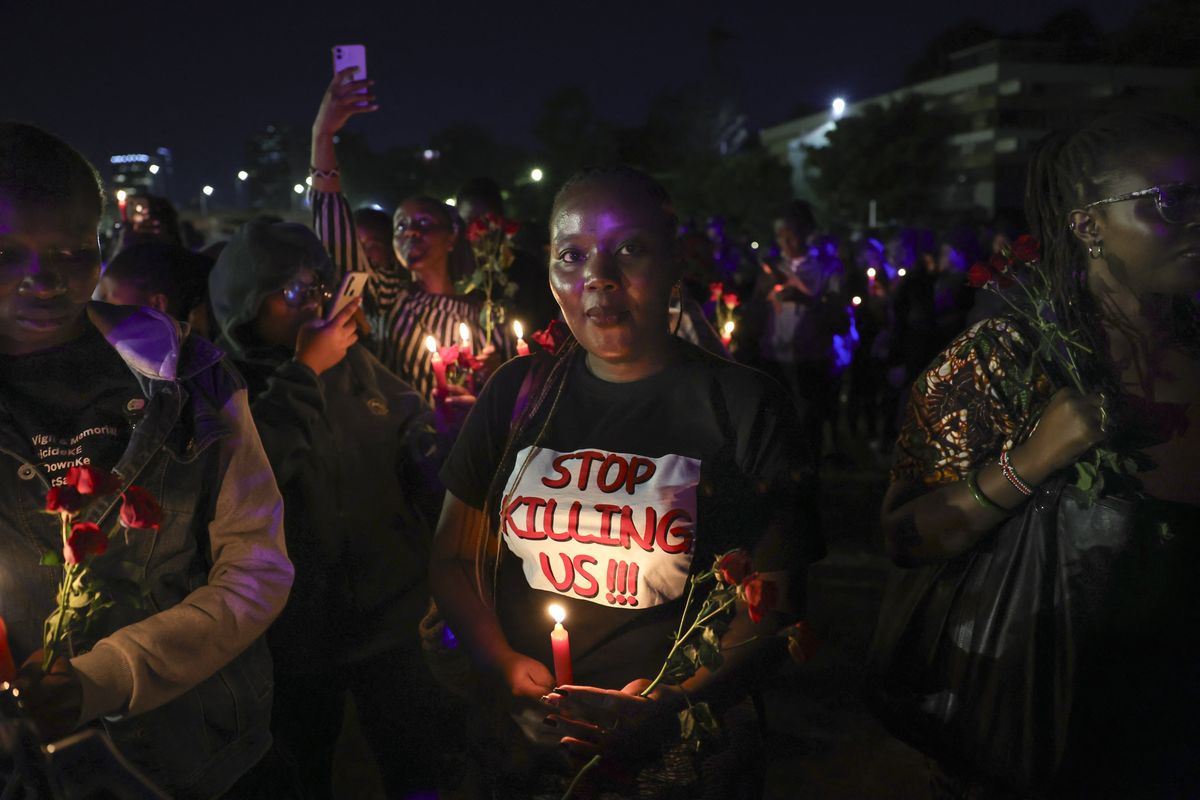 Young people holding candles and flowers to commemorate women killed in incidents of gender-based violence.